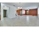 Tile flooring throughout a large living room and natural light from many windows at 18734 Burndall Ct, Land O Lakes, FL 34638