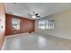 Spacious living room features tile flooring, ceiling fan and natural light from windows at 18734 Burndall Ct, Land O Lakes, FL 34638