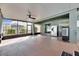 Spacious screened patio with a ceiling fan, stainless steel fridge and space for entertaining at 18734 Burndall Ct, Land O Lakes, FL 34638