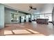 Covered patio with a ceiling fan, hot tub, refrigerator, and sliding glass doors at 18734 Burndall Ct, Land O Lakes, FL 34638