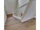 Wooden staircase with white railing that leads to the upper level at 18734 Burndall Ct, Land O Lakes, FL 34638