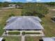 Aerial view of a home with mature trees, well-maintained lawns, and a paved walkway leading to the entrance at 1901 Canterbury Ln # 14, Sun City Center, FL 33573