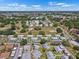 An aerial view of a tranquil community with manicured green spaces and cozy, attached homes under a bright, partly cloudy sky at 1901 Canterbury Ln # 14, Sun City Center, FL 33573