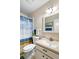 Bathroom featuring updated fixtures, a shower with a decorative curtain, and a bright mirror at 1901 Canterbury Ln # 14, Sun City Center, FL 33573