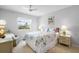 Inviting bedroom with a ceiling fan, a cozy armchair, and a large window with a pleasant view at 1901 Canterbury Ln # 14, Sun City Center, FL 33573