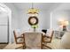 This dining room showcases a unique light fixture, elegant round mirror, and comfortable seating at 1901 Canterbury Ln # 14, Sun City Center, FL 33573