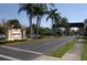 Scenic community entrance featuring the King's Point sign and lush landscaping along the street at 1901 Canterbury Ln # 14, Sun City Center, FL 33573