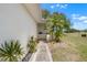 Inviting front entrance with lush greenery and a well-lit walkway at 1901 Canterbury Ln # 14, Sun City Center, FL 33573