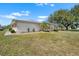 Well-maintained home showcasing a spacious yard and mature landscaping at 1901 Canterbury Ln # 14, Sun City Center, FL 33573