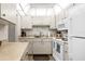 Functional kitchen with white appliances and ample cabinet space at 1901 Canterbury Ln # 14, Sun City Center, FL 33573