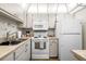 Bright kitchen features white appliances, ample cabinet space, and neutral countertops at 1901 Canterbury Ln # 14, Sun City Center, FL 33573