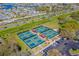 A full aerial view of the tennis courts, showing an impressive layout surrounded by lush greenery at 1901 Canterbury Ln # 14, Sun City Center, FL 33573