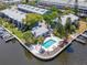 A waterfront townhouse with a private pool and deck, surrounded by lush landscaping and access to the water at 200 Meres Blvd # 7, Tarpon Springs, FL 34689
