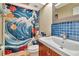 Unique bathroom with bright blue tile and floral shower curtain at 200 Meres Blvd # 7, Tarpon Springs, FL 34689