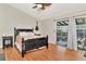 Bedroom featuring a decorative bed, a ceiling fan, and balcony access at 200 Meres Blvd # 7, Tarpon Springs, FL 34689