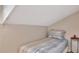 Small bedroom with a slanted ceiling and simple furnishings at 200 Meres Blvd # 7, Tarpon Springs, FL 34689