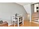 Cozy dining area with table, chairs, and stairs leading to the upper level at 200 Meres Blvd # 7, Tarpon Springs, FL 34689