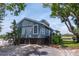 Attractive two-story home with blue siding, lush landscaping, and convenient ramp access at 200 Meres Blvd # 7, Tarpon Springs, FL 34689