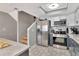 Updated kitchen with stainless steel fridge and views of the staircase at 200 Meres Blvd # 7, Tarpon Springs, FL 34689