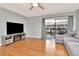 Bright and airy living room with hardwood floors, ceiling fan, large sliding doors to the water at 200 Meres Blvd # 7, Tarpon Springs, FL 34689