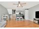 Open-concept living room with hardwood floors, kitchen, and staircase view at 200 Meres Blvd # 7, Tarpon Springs, FL 34689