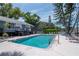 Community pool with lounge chairs, landscaped surroundings, and nearby buildings at 200 Meres Blvd # 7, Tarpon Springs, FL 34689