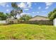 Spacious backyard featuring green grass and an outdoor storage shed at 2001 Spooner Dr, Plant City, FL 33563