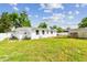 Spacious backyard featuring green grass and an outdoor storage shed at 2001 Spooner Dr, Plant City, FL 33563