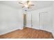 Bright bedroom with wood floors, white walls, closet, ceiling fan, and entrance to bathroom at 2001 Spooner Dr, Plant City, FL 33563