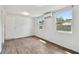 Bright, neutral bedroom with two windows and vinyl flooring at 2001 Spooner Dr, Plant City, FL 33563