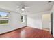 Bright bedroom with wood floor, ceiling fan and natural light at 2001 Spooner Dr, Plant City, FL 33563