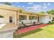 Inviting home with a covered carport, well-manicured lawn, and stylish landscaping, creating a welcoming ambiance at 2001 Spooner Dr, Plant City, FL 33563