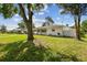 Quaint single-story home with lush green lawn and mature trees, offering a serene setting at 2001 Spooner Dr, Plant City, FL 33563