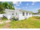 Exterior side view featuring plants, windows and air conditioning unit at 2001 Spooner Dr, Plant City, FL 33563