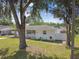 Charming exterior view showcasing the well-maintained home and large trees at 2001 Spooner Dr, Plant City, FL 33563