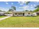 Charming single-story home features a well-maintained lawn, inviting curb appeal, and covered carport at 2001 Spooner Dr, Plant City, FL 33563