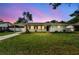 Charming single-story home features a well-maintained lawn, inviting curb appeal, and covered carport at 2001 Spooner Dr, Plant City, FL 33563