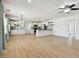 Bright open-concept layout with wood flooring connects the kitchen and dining area, great for entertaining at 2001 Spooner Dr, Plant City, FL 33563