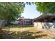 Spacious backyard with large, shaded trees and carport at 2087 59Th N St, Clearwater, FL 33760