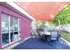 Back patio covered by a shade sail with an outdoor seating area, perfect for relaxation at 2087 59Th N St, Clearwater, FL 33760