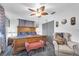 Comfortable bedroom with a decorative ceiling fan, stylish furnishings, and ample closet space at 2087 59Th N St, Clearwater, FL 33760