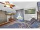 Cozy bedroom featuring unique ceiling fan, stylish curtains, and decorative accents at 2087 59Th N St, Clearwater, FL 33760