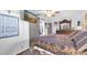 Bedroom with sliding barn door, decorative wall art, and cozy patterned bedding at 2087 59Th N St, Clearwater, FL 33760