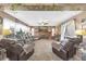 Comfortable living room with large stone fireplace, plush seating, and ceiling fan at 2087 59Th N St, Clearwater, FL 33760