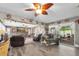 Inviting living room with stone fireplace, plush seating, and a sliding door to outdoor space at 2087 59Th N St, Clearwater, FL 33760