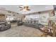 Open-concept living room with plush seating, geometric rug, and view to the kitchen at 2087 59Th N St, Clearwater, FL 33760