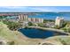 Overhead shot showcasing water views, golf course, pond and building with pristine landscaping at 2614 Cove Cay Dr # 301, Clearwater, FL 33760