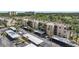 Aerial view displaying condo buildings with convenient covered parking, lush palms, and landscaping at 2614 Cove Cay Dr # 301, Clearwater, FL 33760