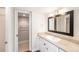 Well-lit bathroom with view into closet and single sink vanity with stone counter top at 2614 Cove Cay Dr # 301, Clearwater, FL 33760