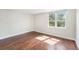 This bedroom features beautiful wood floors and a large window offering lots of natural light at 2614 Cove Cay Dr # 301, Clearwater, FL 33760